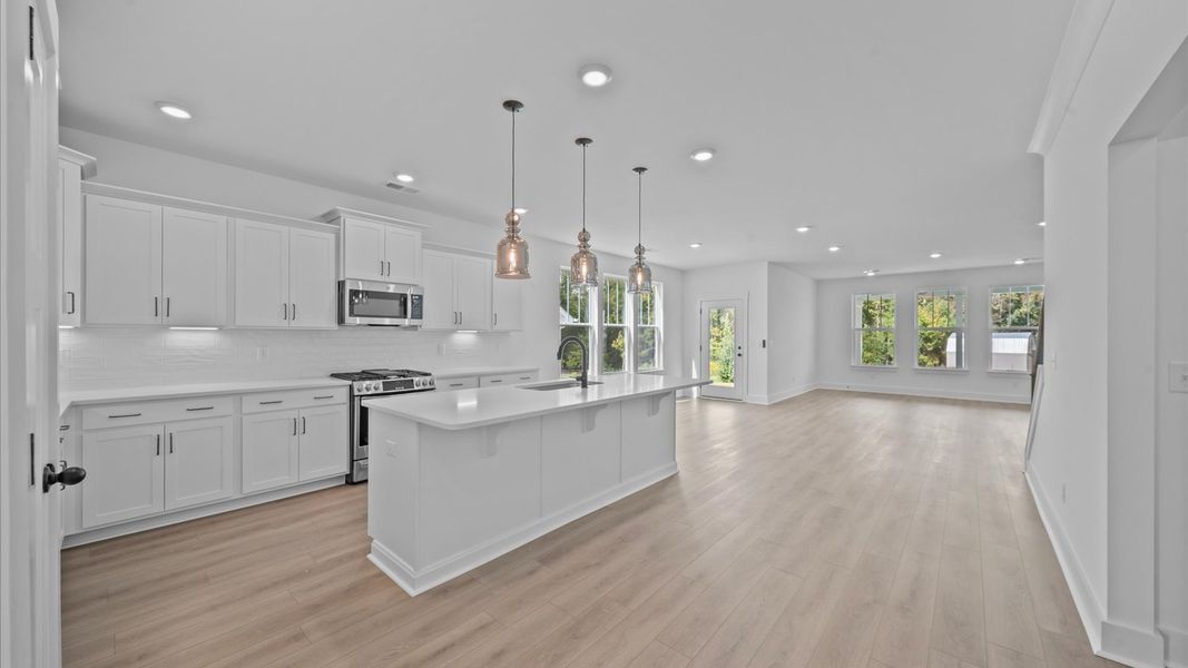 Exceptional culinary space with a striking 9-foot island and eye-catching pendant lights Exceptional culinary space with a striking 9-foot island and eye-catching pendant lights