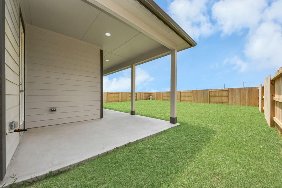 Experience outdoor living at its finest on this expansive covered patio, thoughtfully designed for BBQs and delightful outdoor dining.