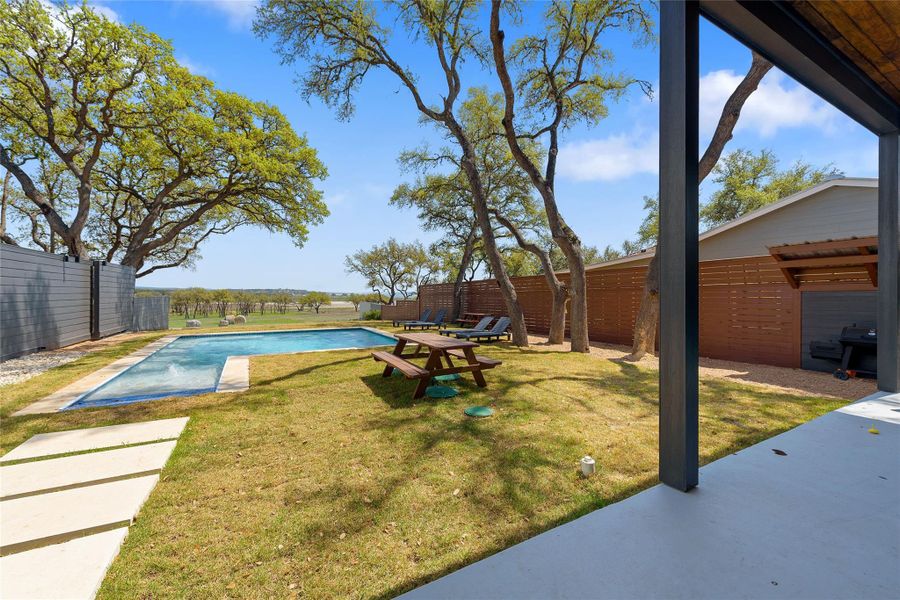 Unwind on the covered back patio with peaceful Hill Country views and a spacious yard perfect for entertaining or soaking in the Canyon Lake breeze. A serene setting for morning coffee or evening sunsets. Unwind on the covered back patio with peaceful Hill Country views and a spacious yard perfect for entertaining or soaking in the Canyon Lake breeze. A serene setting for morning coffee or evening sunsets.