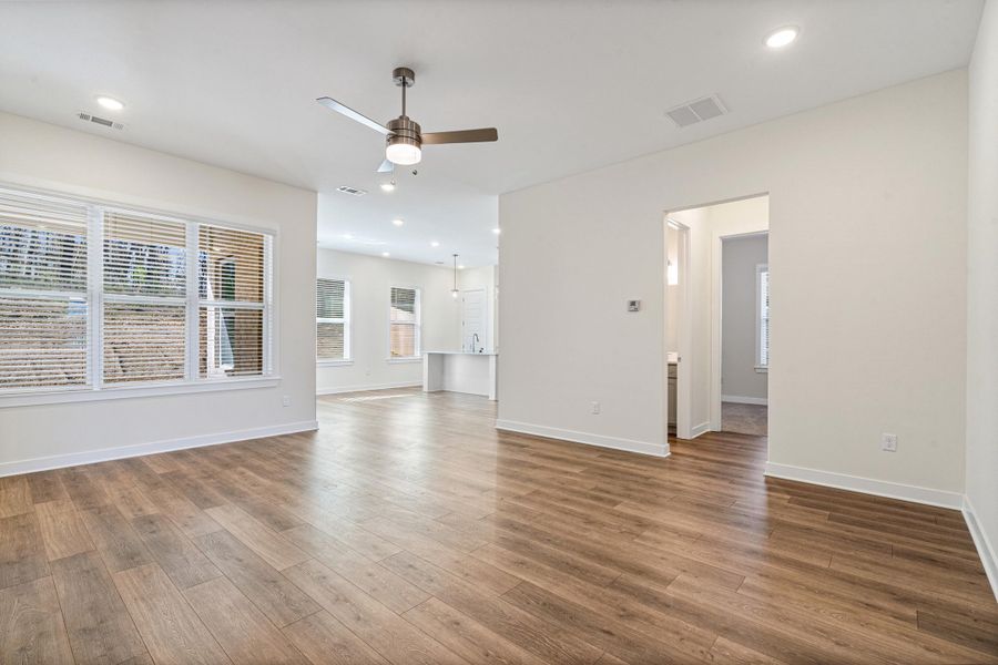 Empty room with recessed lighting, ceiling fan, and dark wood finished floors