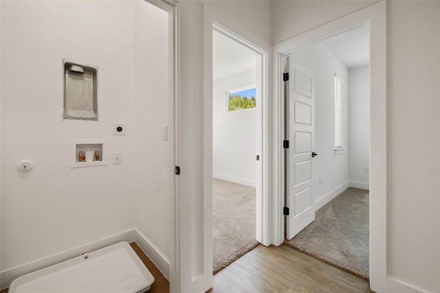 Laundry room featuring electric dryer hookup, wood finished floors, washer hookup, and carpet Laundry room featuring electric dryer hookup, wood finished floors, washer hookup, and carpet