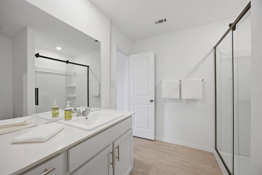 Clean lines and a spacious glass shower define this contemporary bathroom.