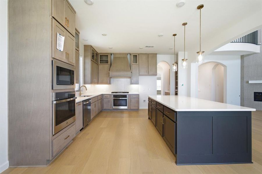 Modern kitchen with light wood-finish flooring Modern kitchen with light wood-finish flooring