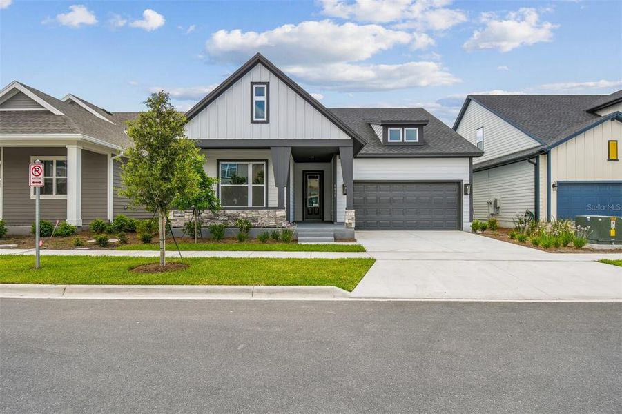 Front exterior of a new home in Weslyn Park in Sunbridge 50', St. Cloud, FL, highlighting curb appeal (Image 2).