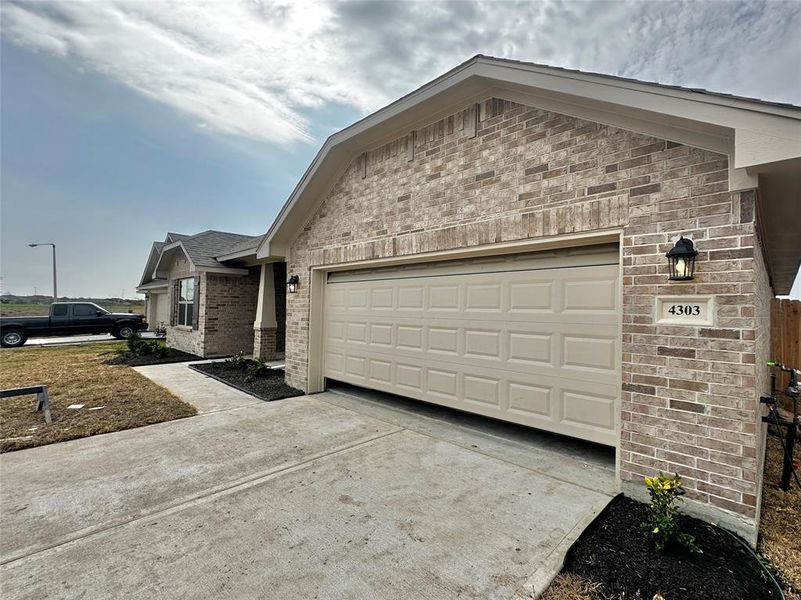 Front exterior of a new home in Cobblestone, Texas City, TX, highlighting curb appeal (Image 2). Front exterior of a new home in Cobblestone, Texas City, TX, highlighting curb appeal (Image 2).
