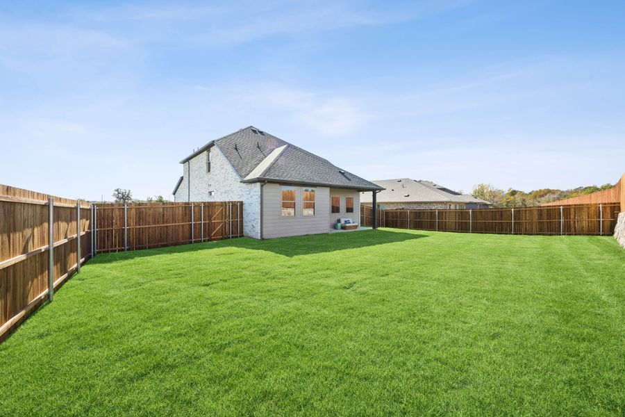 Covered Patio in a Belmont Magnolia Model Home in Aubrey TX by Trophy Signature Homes