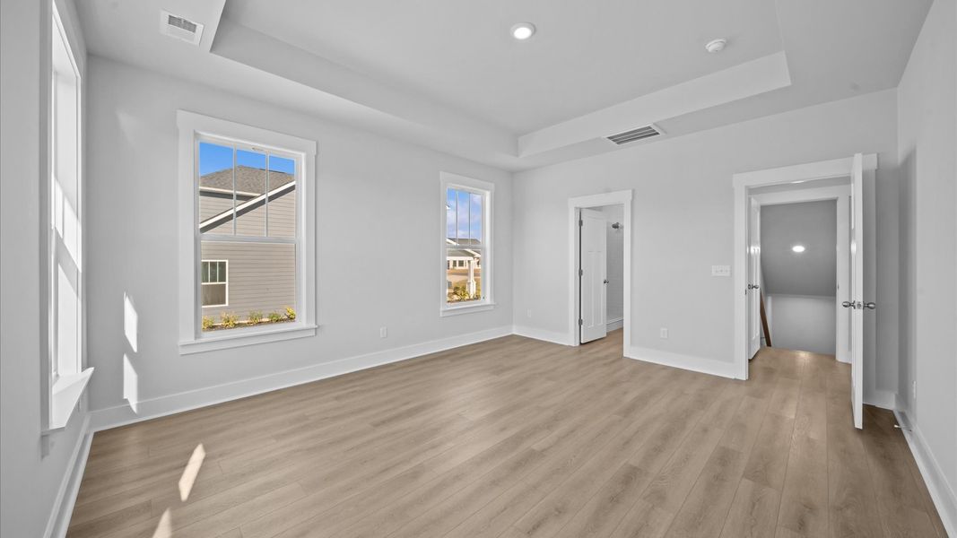 First-class hardwood floors and tasteful finishes elevate the private retreat of this exceptional primary suite