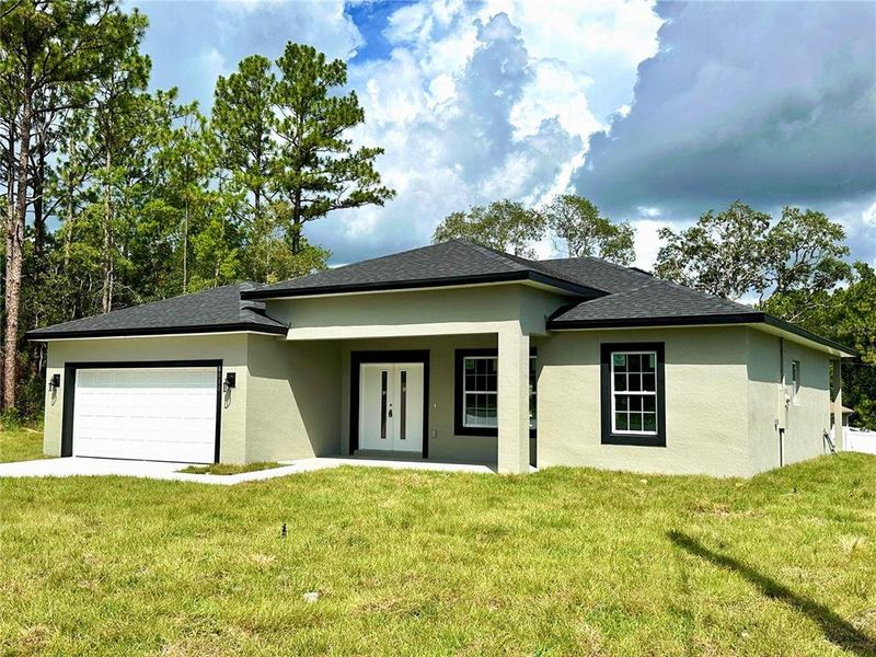 Front exterior of a new home in , Citrus Springs, FL, highlighting curb appeal (Image 23).