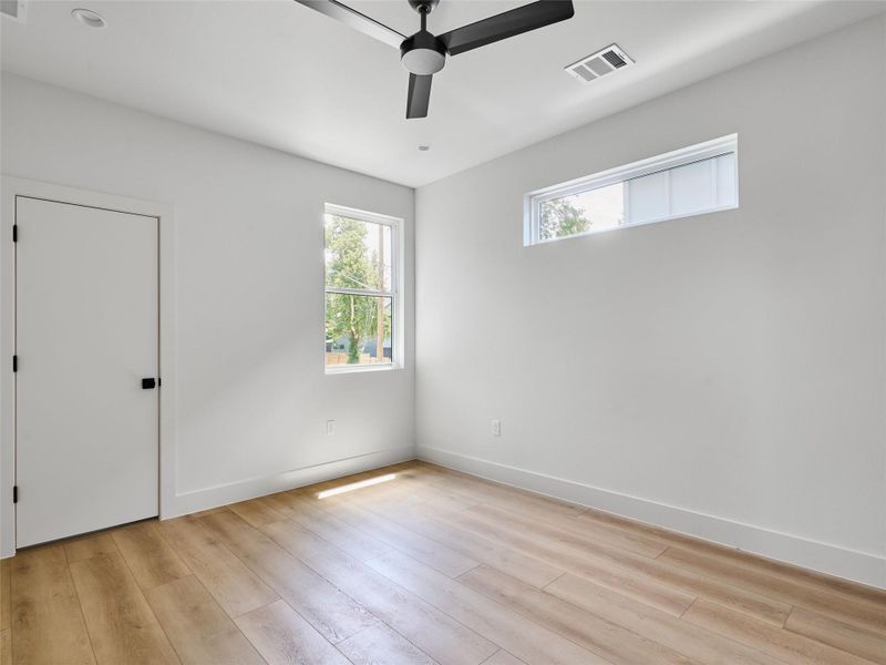 Empty room with ceiling fan and light wood finished floors Empty room with ceiling fan and light wood finished floors