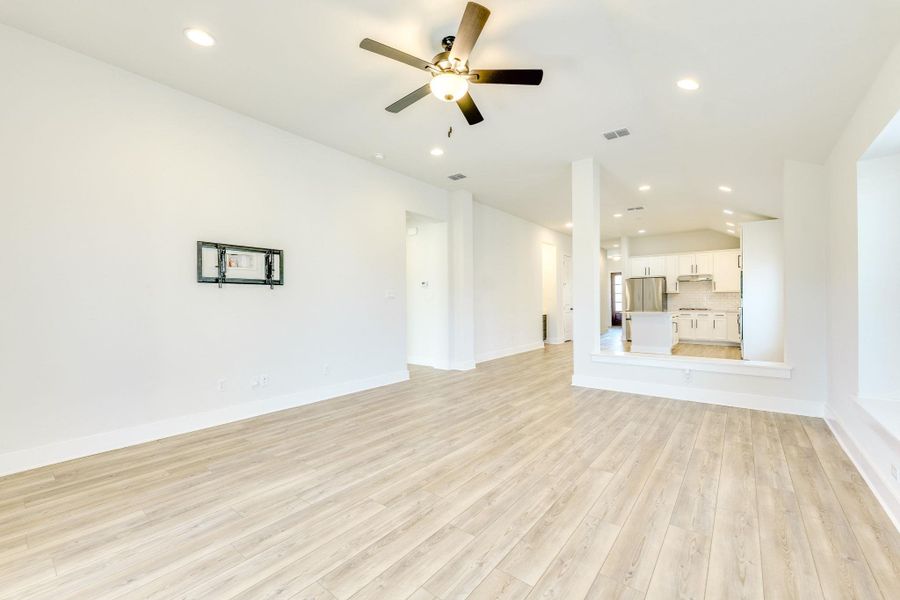 Unfurnished living room featuring light wood-style floors, recessed lighting, and a ceiling fan