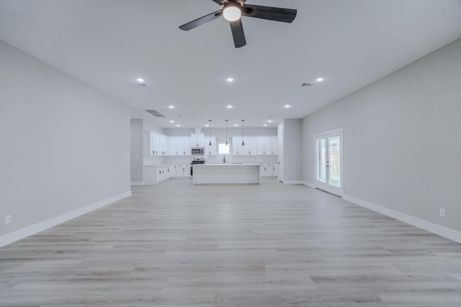 High ceilings and luxury vinyl plank flooring throughout living areas