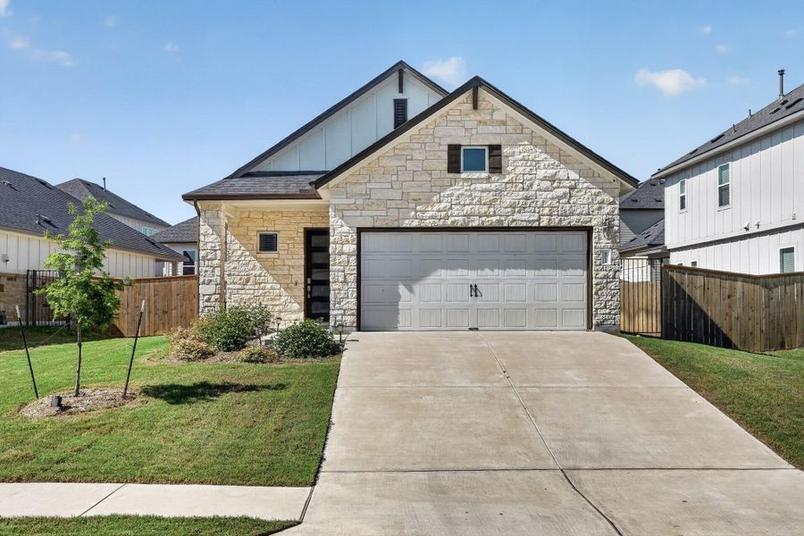 Front exterior of a new home in Cascades at Onion Creek, Austin, TX, highlighting curb appeal (Image 23).