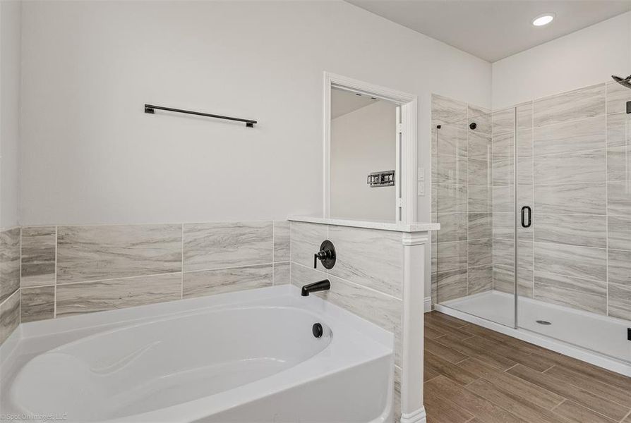 Luxurious primary ensuite bath with garden soaking tub and separate shower