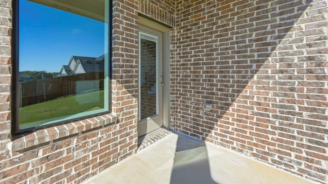 Property entrance featuring brick siding Property entrance featuring brick siding