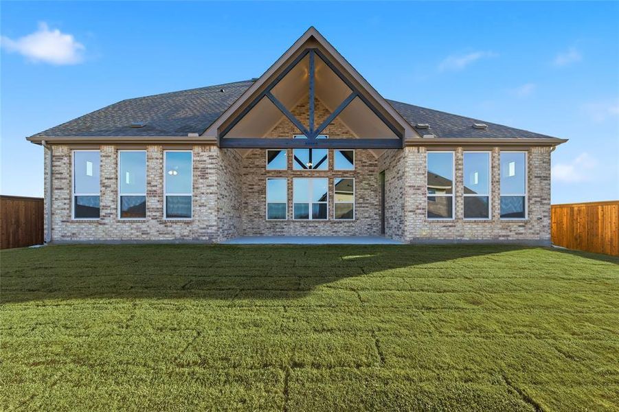 Rear view of property featuring a patio area and brick siding Rear view of property featuring a patio area and brick siding