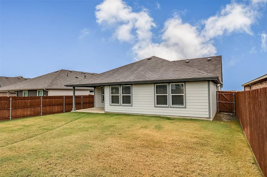 Back of house with a patio area, a shingled roof, and a fenced backyard Back of house with a patio area, a shingled roof, and a fenced backyard