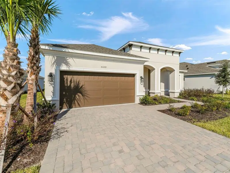 Front exterior of a new home in Esplanade at Westview, Kissimmee, FL, highlighting curb appeal (Image 2). Front exterior of a new home in Esplanade at Westview, Kissimmee, FL, highlighting curb appeal (Image 2).