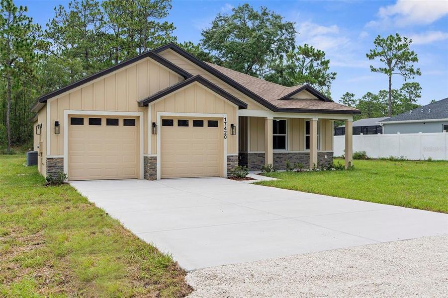 Front exterior of a new home in , Weeki Wachee, FL, highlighting curb appeal (Image 26). Front exterior of a new home in , Weeki Wachee, FL, highlighting curb appeal (Image 26).