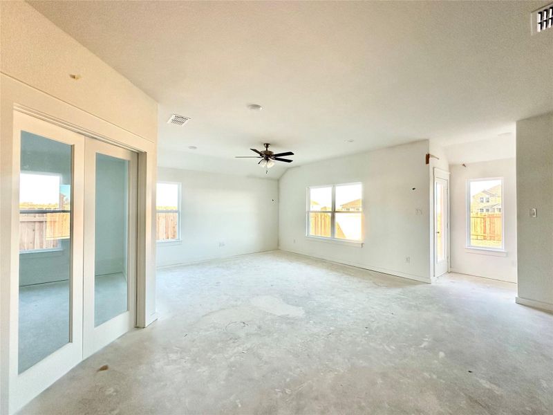 Empty room featuring french doors, healthy amount of natural light, and ceiling fan