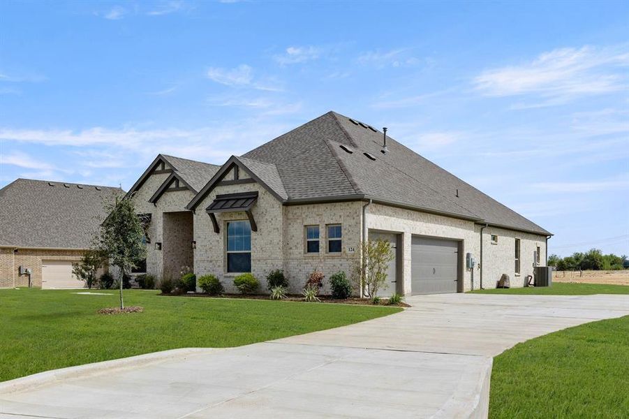 Front exterior of a new home in Settler's Glen, New Fairview, TX, highlighting curb appeal (Image 1). Front exterior of a new home in Settler's Glen, New Fairview, TX, highlighting curb appeal (Image 1).