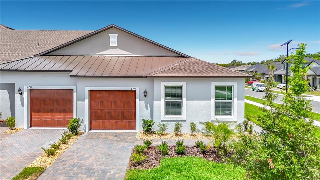Front exterior of a new home in New Port Corners Active Adult, New Port Richey, FL, highlighting curb appeal (Image 2). Front exterior of a new home in New Port Corners Active Adult, New Port Richey, FL, highlighting curb appeal (Image 2).
