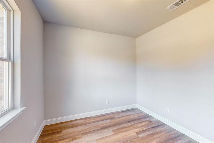 Empty room featuring light wood-type flooring