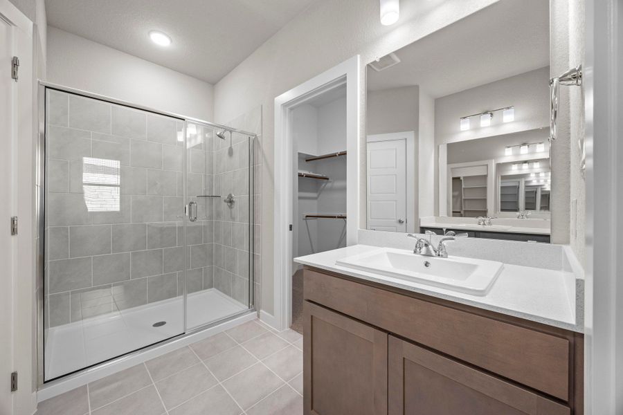 Primary Bathroom in the Cedar home plan by Trophy Signature Homes – REPRESENTATIVE PHOTO