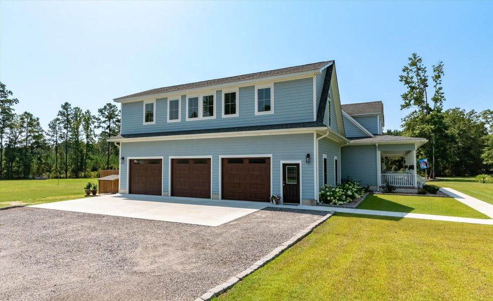 Front exterior of a new home in , Ravenel, SC, highlighting curb appeal (Image 1). Front exterior of a new home in , Ravenel, SC, highlighting curb appeal (Image 1).