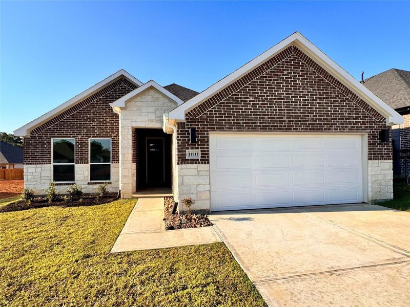 Front exterior of a new home in Lexington Heights, Willis, TX, highlighting curb appeal (Image 24).