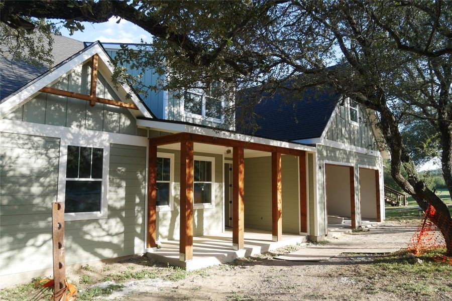 Close-up of the porch showcasing architectural details and fresh construction elements. Close-up of the porch showcasing architectural details and fresh construction elements.