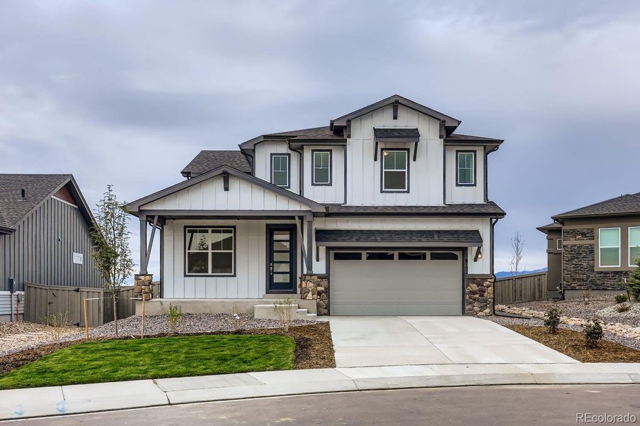 Front exterior of a new home in Sterling Ranch Homestead 60s, Colorado Springs, CO, highlighting curb appeal (Image 1).