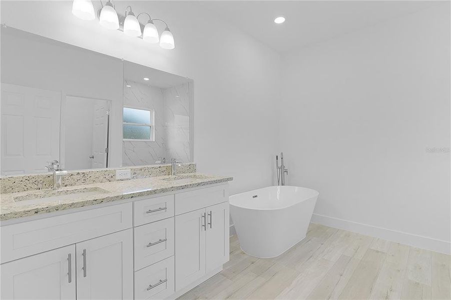 Primary bathroom with dual sinks and a gorgeous soaking tub