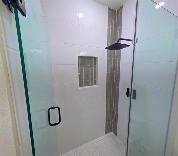 Full bath featuring a shower stall Full bath featuring a shower stall