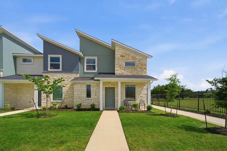 Front exterior of a new home in Municipal Drive Townhomes, Leander, TX, highlighting curb appeal (Image 1). Front exterior of a new home in Municipal Drive Townhomes, Leander, TX, highlighting curb appeal (Image 1).