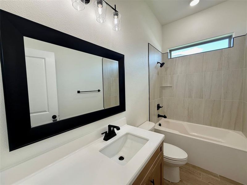 Full bathroom featuring vanity, bathtub / shower combination, and wood finished floors