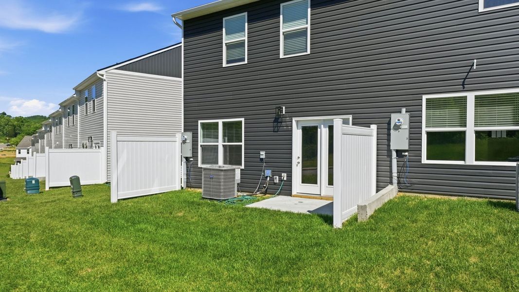 Exterior details and patio area of a home in The Arbor Townhomes, Kingsport (Image 18).