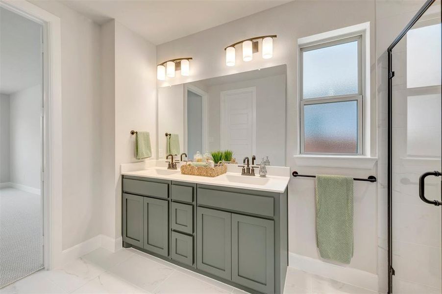 Dual sink vanity with grey cabinetry and white countertops