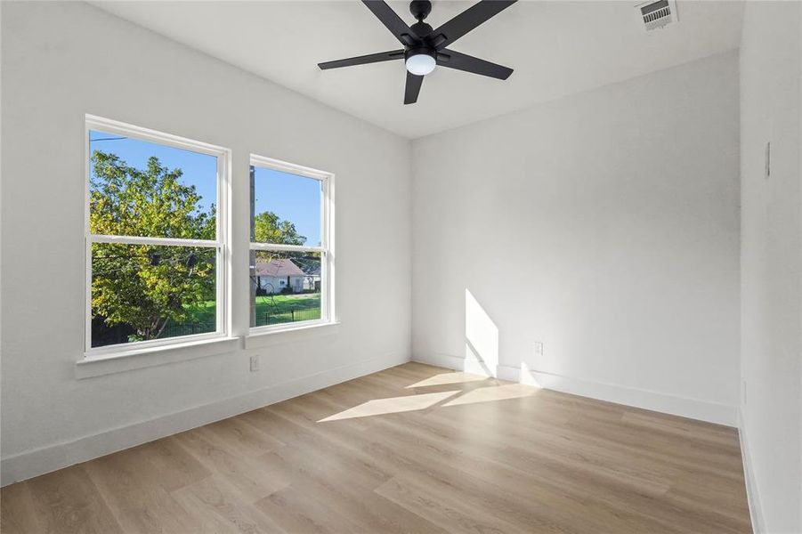 Spare room with light wood finished floors and ceiling fan Spare room with light wood finished floors and ceiling fan