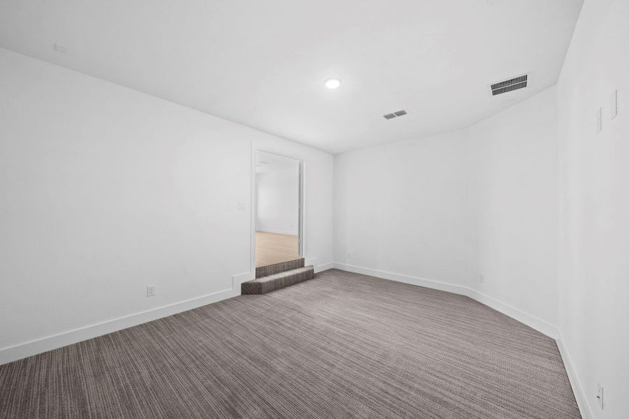Spacious upstairs game room with open floor plan, high ceilings, and abundant natural light.