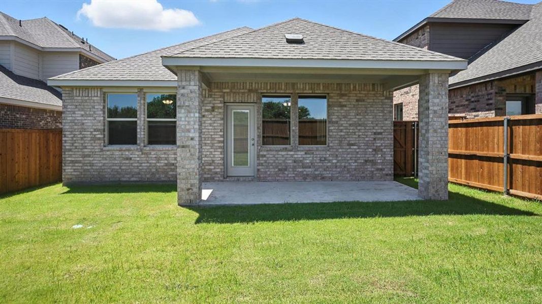 Back of house featuring a patio area, brick siding, a fenced backyard, and a shingled roof Back of house featuring a patio area, brick siding, a fenced backyard, and a shingled roof