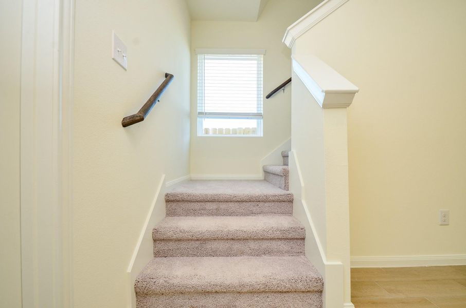 The well-lit staircase offers a smooth transition between levels.