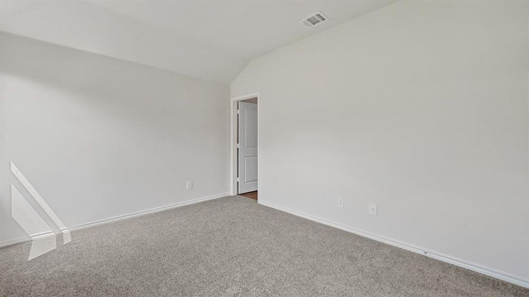 Neutral paint palette with vaulted ceilings and light gray carpet