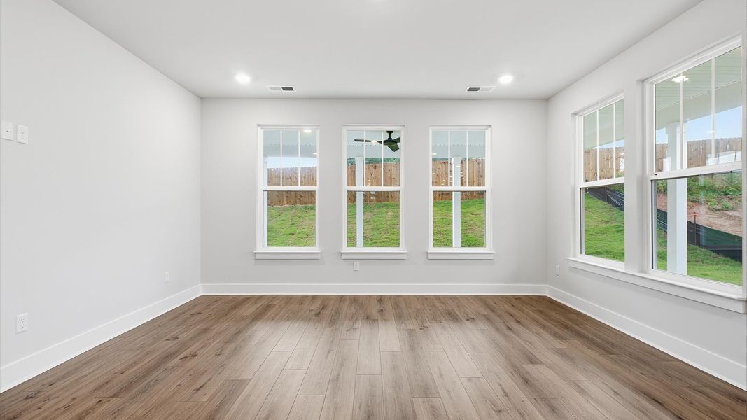 Vibrant and welcoming family room anchored by clean lines, tasteful materials, and abundant light by DRB Homes Vibrant and welcoming family room anchored by clean lines, tasteful materials, and abundant light by DRB Homes