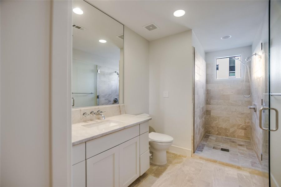 Master Bath (closet not pictured). Outlets hidden inside custom cabinetry & storage