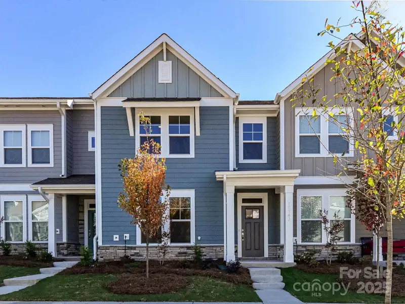 Front exterior of a new home in North Creek Village, Huntersville, NC, highlighting curb appeal (Image 1). Front exterior of a new home in North Creek Village, Huntersville, NC, highlighting curb appeal (Image 1).