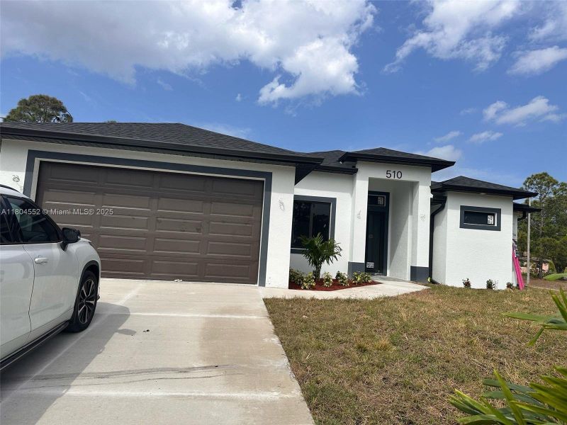 Front exterior of a new home in , Lehigh Acres, FL, highlighting curb appeal (Image 23). Front exterior of a new home in , Lehigh Acres, FL, highlighting curb appeal (Image 23).