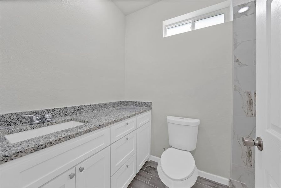 Bathroom featuring vanity and wood finish floors