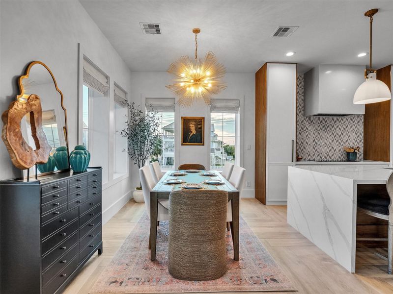 Enjoy meals with preserved Gulf views and abundant natural light. The extendable French Contemporary table effortlessly adapts from six to ten guests, letting you host in style while maintaining a clean, uninterrupted silhouette. With Lutron lighting and automated shades enhancing every moment, this dining space blends sophisticated design with relaxed coastal living. Enjoy meals with preserved Gulf views and abundant natural light. The extendable French Contemporary table effortlessly adapts from six to ten guests, letting you host in style while maintaining a clean, uninterrupted silhouette. With Lutron lighting and automated shades enhancing every moment, this dining space blends sophisticated design with relaxed coastal living.