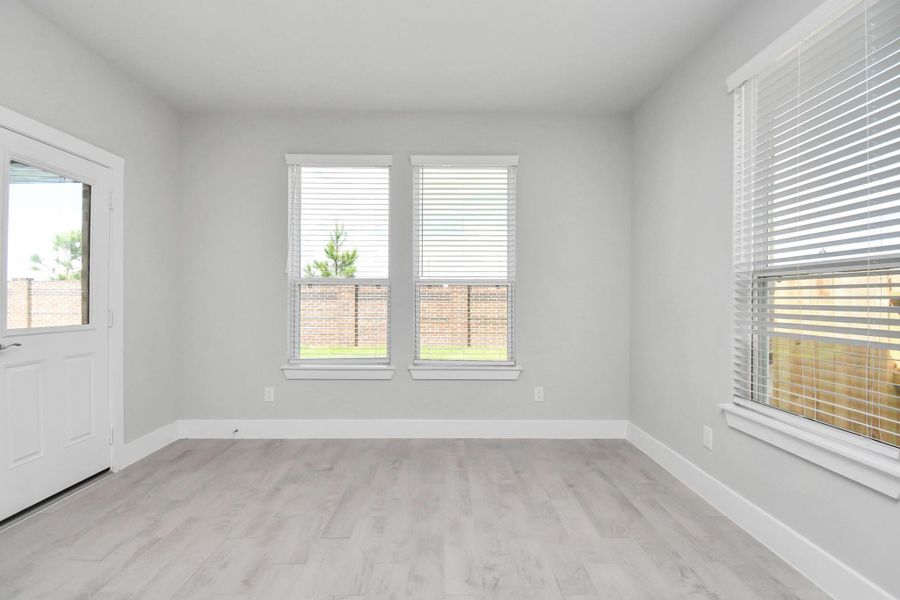 Step through the back door for a breath of fresh air onto the covered patio, extending your living space to the outdoors. Sample photo of completed home with similar floor plan. Actual colors and selections may vary.