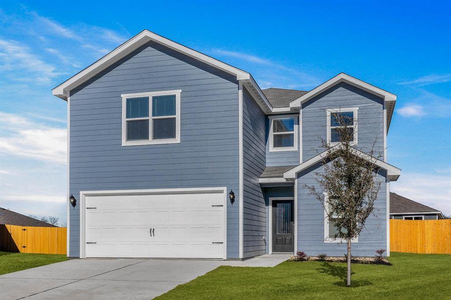 View of front of home with a front yard and a garage